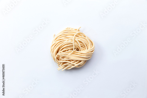 Dry homemade pasta. Isolated on white.