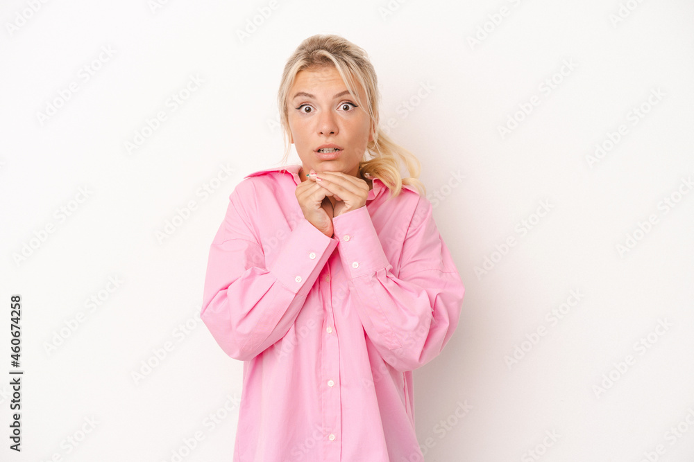 Young Russian woman isolated on white background praying for luck, amazed and opening mouth looking to front.