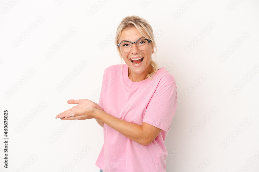 Young Russian woman isolated on white background holding a copy space on a palm. Young Russian woman isolated on white background holding a copy space on a palm.