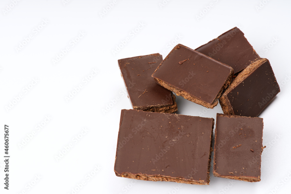 Pieces of closeup chocolate on a white background. Pieces of closeup chocolate on a white background.