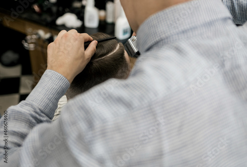 barber cuts the customer's hair