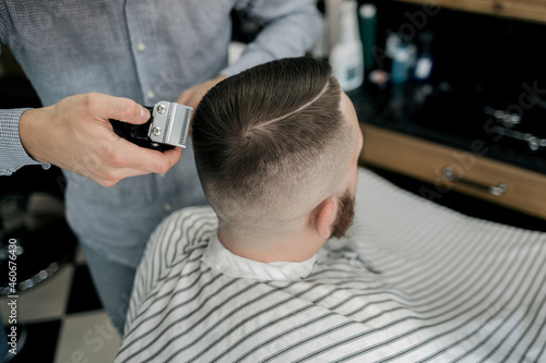 man being trimmed with professional electric clipper machine © jozzeppe777