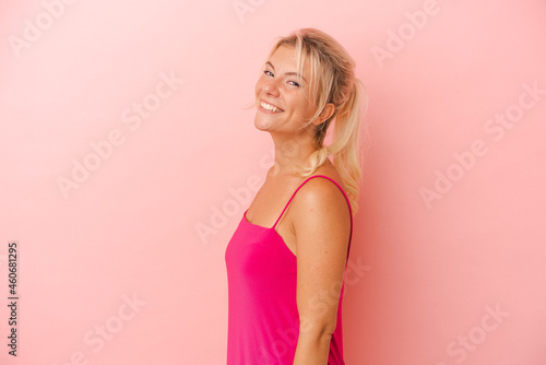 Young Russian woman isolated on pink background confident keeping hands on hips.