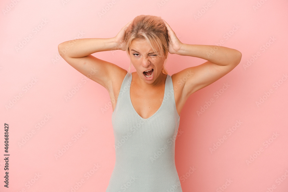 Young Russian woman isolated on pink background screaming, very excited, passionate, satisfied with something. Young Russian woman isolated on pink background screaming, very excited, passionate, satisfied with something.