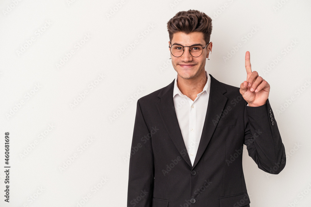 Young business caucasian man wearing headphones isolated on white background showing number one with finger. Young business caucasian man wearing headphones isolated on white background showing number one with finger.