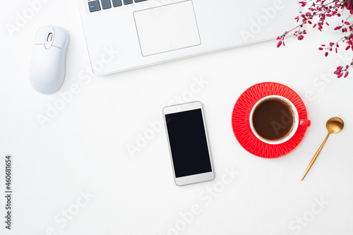 Flat Lay mockup of smartphone with blank screen and cup of coffee, branches with red berries, laptop on a white background