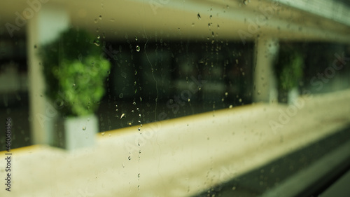 Closeup of the outside view from a window covered in waterdrops, during dayl photo