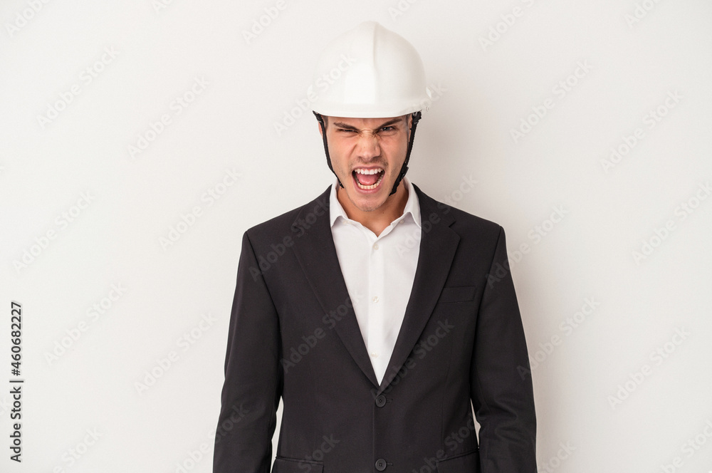 Young architect caucasian man isolated on white background screaming very angry and aggressive. Young architect caucasian man isolated on white background screaming very angry and aggressive.