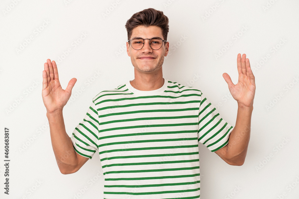 Young caucasian man isolated on white background holding something little with forefingers, smiling and confident. Young caucasian man isolated on white background holding something little with forefingers, smiling and confident.