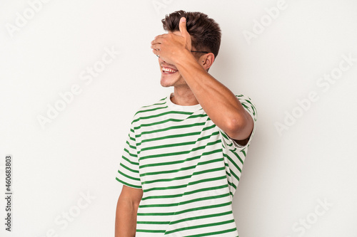 Young caucasian man isolated on white background laughs out loudly keeping hand on chest. © Asier