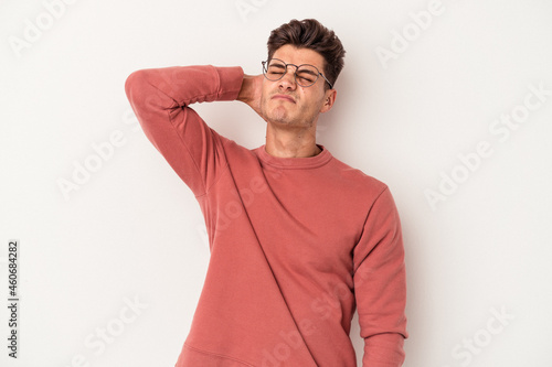 Young caucasian man isolated on white background massaging elbow, suffering after a bad movement.