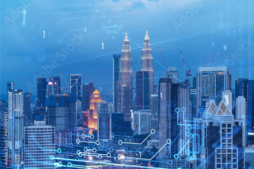 Information flow hologram  night panorama city view of Kuala Lumpur. KL is the largest technological center in Malaysia  Asia. The concept of programming science. Double exposure.