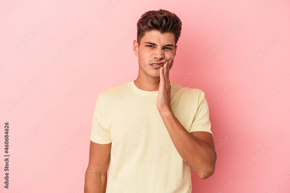 Young caucasian man isolated on pink background having a strong teeth pain, molar ache. Young caucasian man isolated on pink background having a strong teeth pain, molar ache.