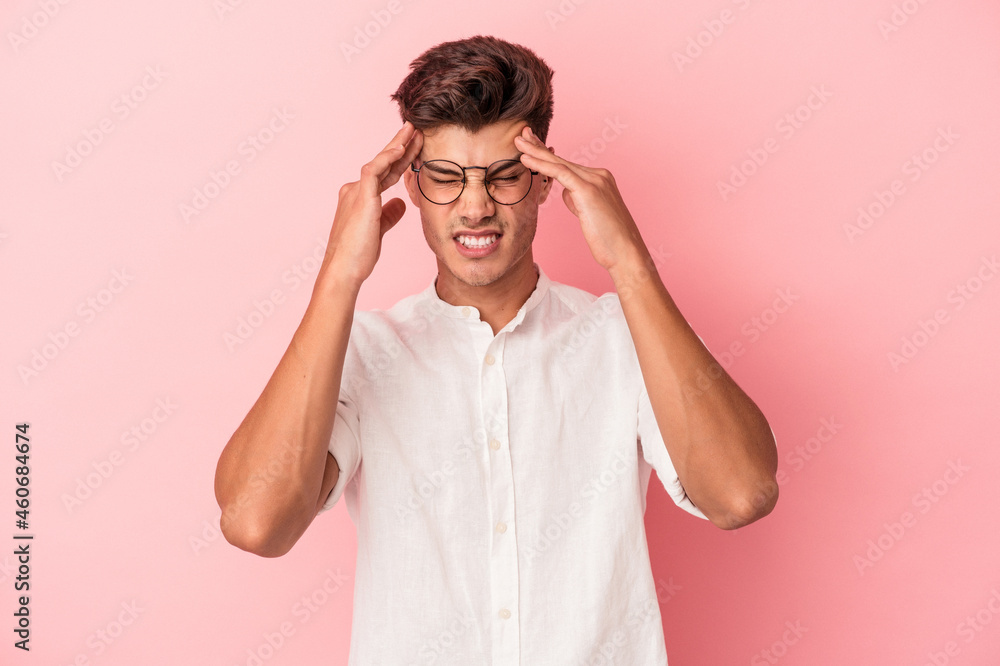 Young caucasian man isolated on pink background touching temples and having headache. Young caucasian man isolated on pink background touching temples and having headache.