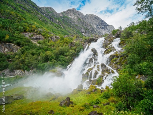 Kleivafossen waterfalls and mountains near briksdalsbreen Glacier in Norway.
