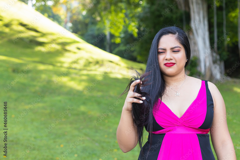 Hispanic woman taking selfie with mobile in the park Hispanic woman taking selfie with mobile in the park