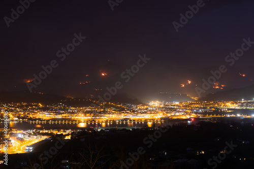 Night at Irun while a wild fire destroys the near mountains.