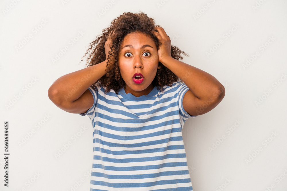 Young african american woman with curly hair isolated on white background being shocked, she has remembered important meeting. Young african american woman with curly hair isolated on white background being shocked, she has remembered important meeting.