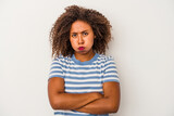 Young african american woman with curly hair isolated on white background blows cheeks, has tired expression. Facial expression concept.