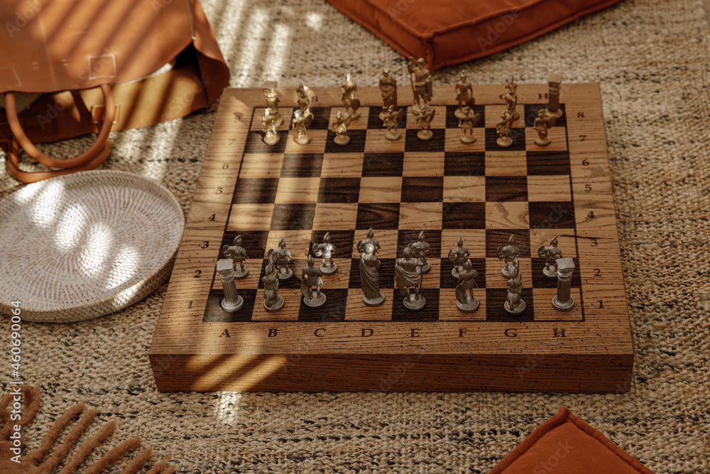 Ancient metal Roman Chess Set with silver and gold plated pieces on solid oak wood Board. Concept image for business strategy, competition, relaxation, recreation and mental agility. Ancient metal Roman Chess Set with silver and gold plated pieces on solid oak wood Board. Concept image for business strategy, competition, relaxation, recreation and mental agility.