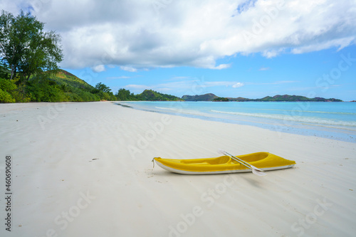 boat on tropical beach at anse volbert on praslin, seychelles