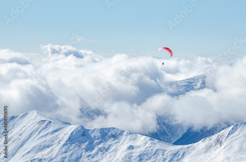 Paraglider is flying over the mountains in Gudauri, Georgia