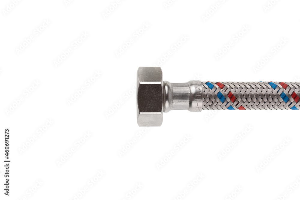 Flexible liner for water supply on a white background. Close-up of flexible metal braided hose. Flexible liner for water supply on a white background. Close-up of flexible metal braided hose.