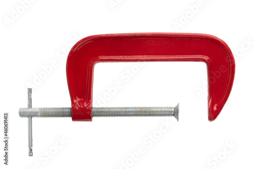 Red clamp on a white background. Joiner's clamp close-up. photo