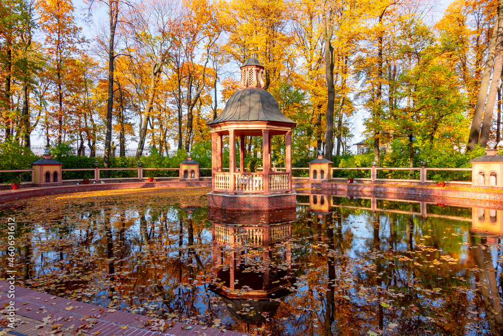 Fototapeta premium Gazebo and pond in Summer garden in autumn, Saint Petersburg, Russia