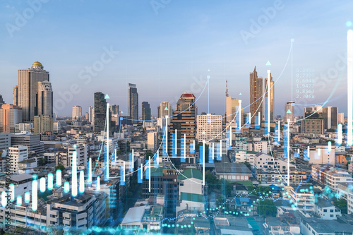Glowing FOREX graph hologram, aerial panoramic cityscape of Bangkok at sunset. Stock and bond trading in Southeast Asia. The concept of fund management. Double exposure. © VideoFlow