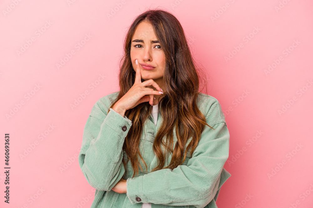 Young caucasian woman isolated on pink background unhappy looking in camera with sarcastic expression. Young caucasian woman isolated on pink background unhappy looking in camera with sarcastic expression.