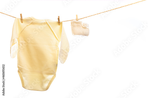 Baby clothes on a clothesline on white background