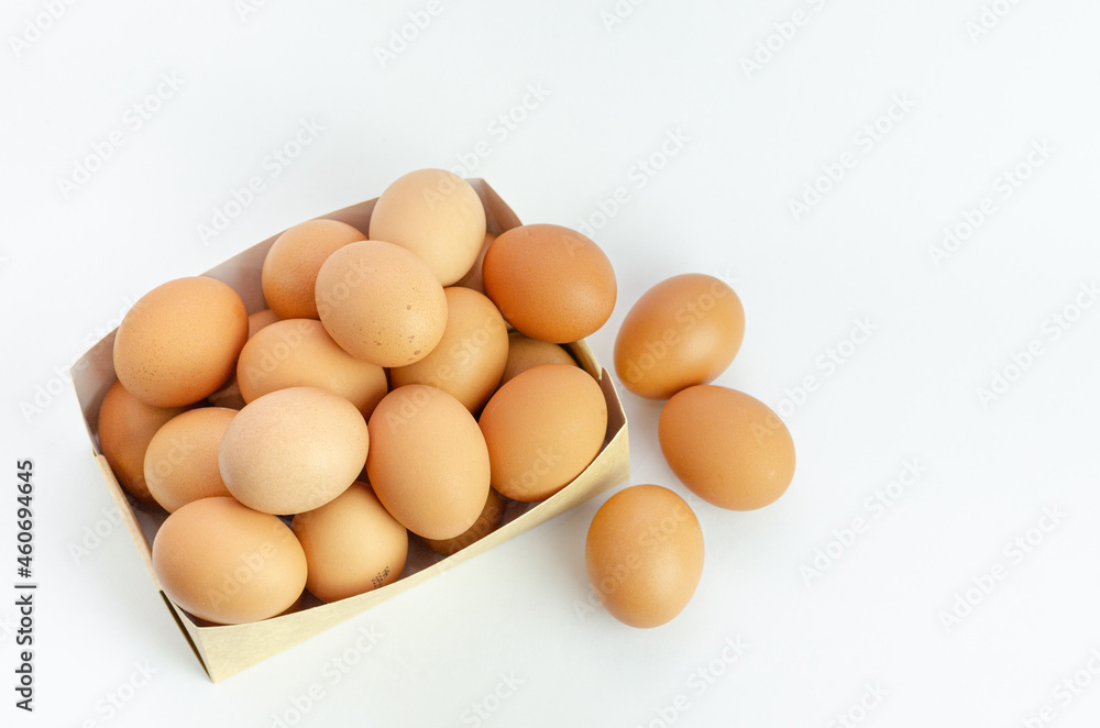 Eggs inside brown ready cardboard box, on white background. Fresh eggs for the kitchen. Copy space. Eggs inside brown ready cardboard box, on white background. Fresh eggs for the kitchen. Copy space.