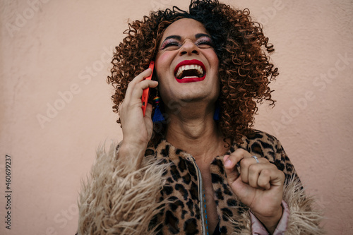 curly haired tranny talking on the phone in the street photo