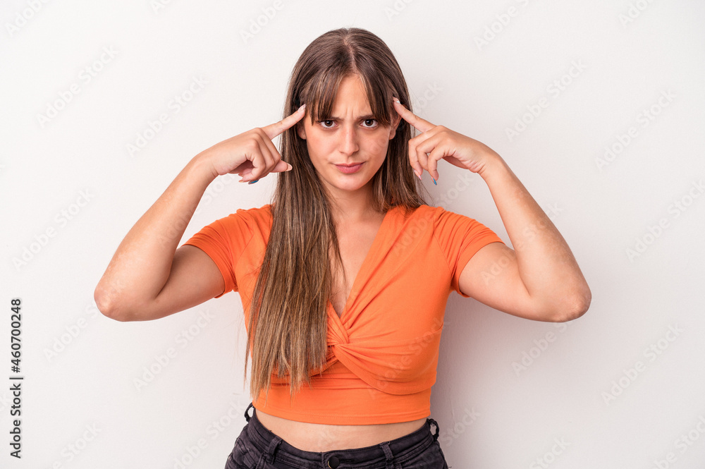 Young caucasian woman isolated on white background focused on a task, keeping forefingers pointing head. Young caucasian woman isolated on white background focused on a task, keeping forefingers pointing head.