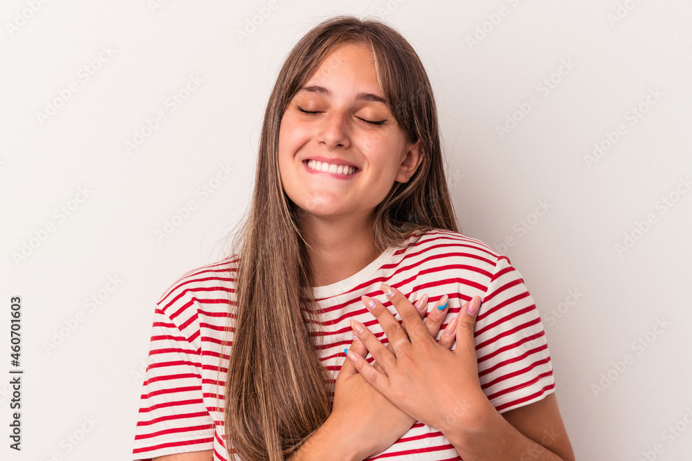 Young caucasian woman isolated on white background has friendly expression, pressing palm to chest. Love concept. Young caucasian woman isolated on white background has friendly expression, pressing palm to chest. Love concept.