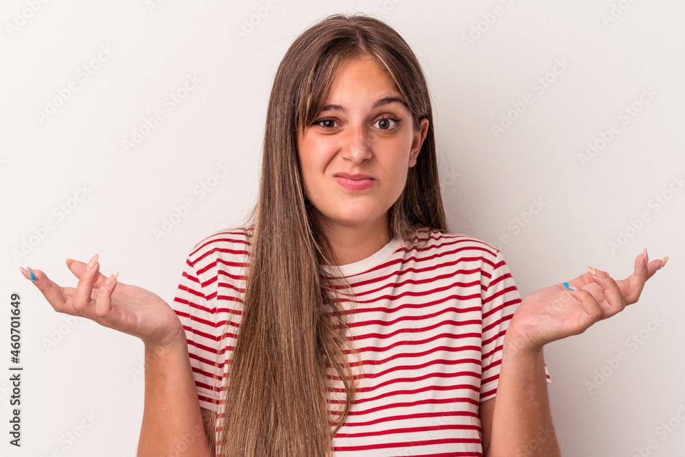 Young caucasian woman isolated on white background doubting and shrugging shoulders in questioning gesture. Young caucasian woman isolated on white background doubting and shrugging shoulders in questioning gesture.
