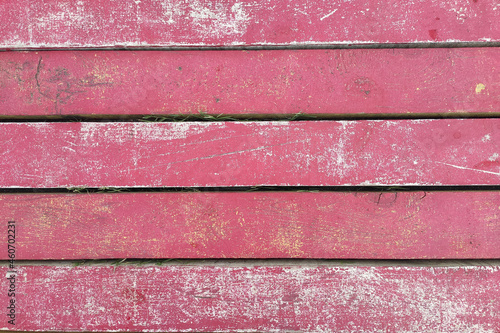 Old wooden texture with grunge pink paint. Wood texture in vintage style.