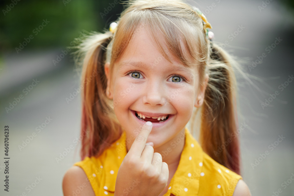 Toothless childrens smile. Little cute girl child laughs, shows the
