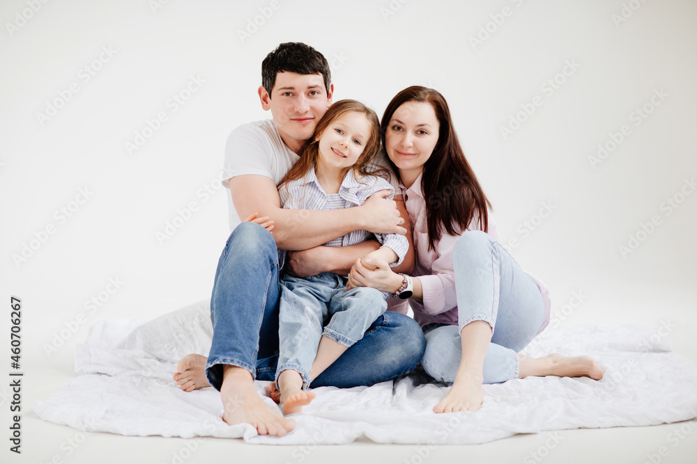beautiful happy family cuddling in a white photo studio. backstage. beautiful happy family cuddling in a white photo studio. backstage.