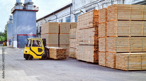 Forklift loads lumber into stacks at the finished product warehouse