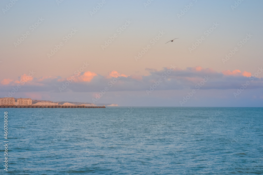 Sea at sunset, clear sky and light waves