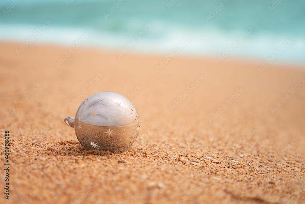 A lonely glass Christmas tree ball on the sandy seashore. Copy space. A lonely glass Christmas tree ball on the sandy seashore. Copy space.