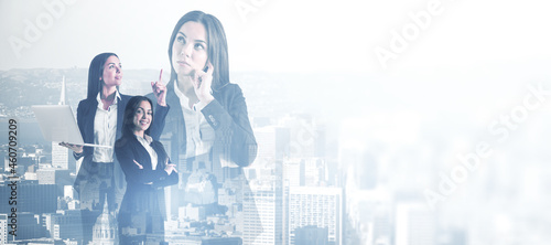 Attractive young european businesswomen standing together on abstract city and sky background with white mock up place. Teamwork, success and colleagues concept. Double exposure.