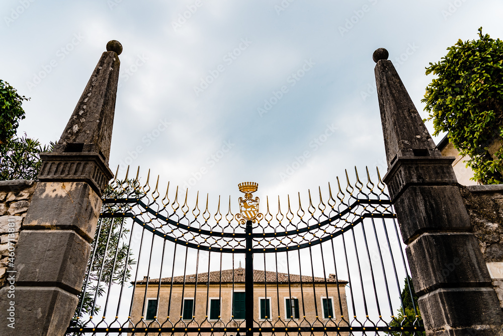 Fototapeta premium Classic stately door with coat of arms at the entrance of an Italian villa.