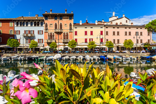 Desenzano del Garda, Italy - September 22, 2021: View of the small old port of Lake Garda a sunny day in Desenzano. photo