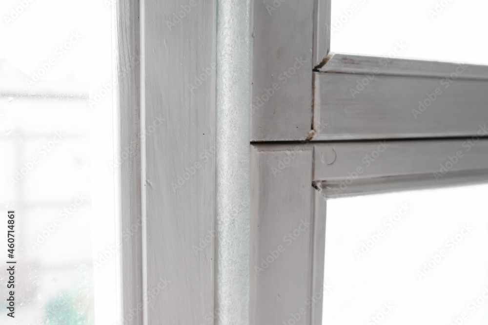 Insulated old window frames to prevent warmth heat leak and drafts, preparing house for winter and cold weather Insulated old window frames to prevent warmth heat leak and drafts, preparing house for winter and cold weather