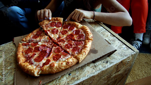 One big pepperoni pizza for a group of dancers after a training 