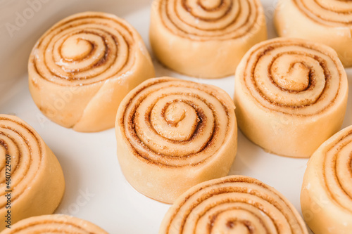Baking dish with uncooked cinnamon rolls, closeup