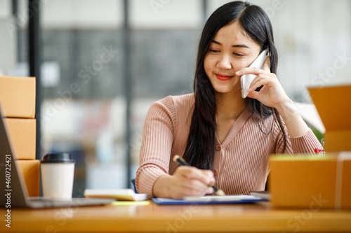 Portrait of Starting small businesses SME owners female entrepreneurs working on receipt box and check online orders to prepare to pack the boxes, sell to customers, sme business ideas online. photo